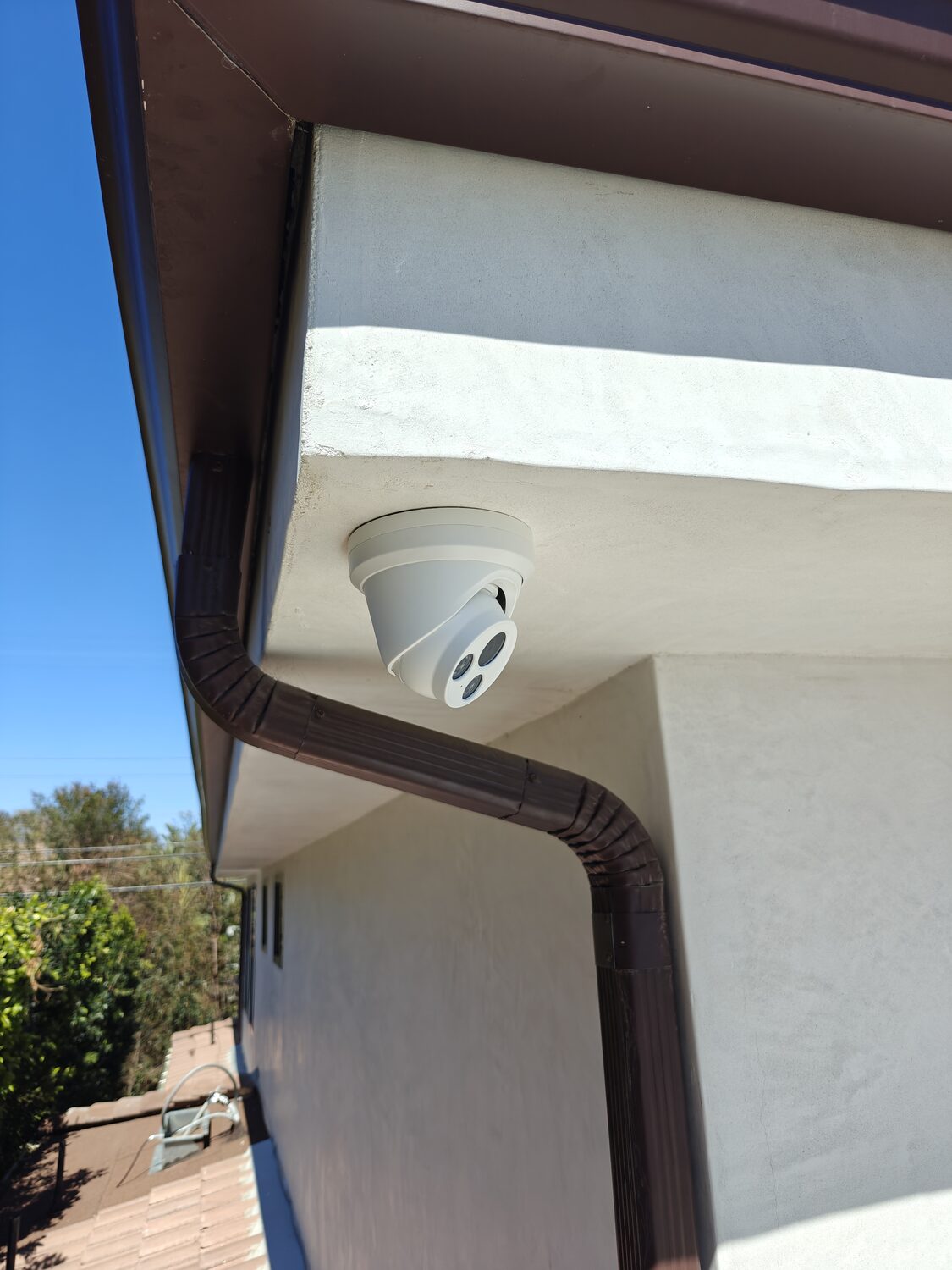 Turret security camera installed under an eave